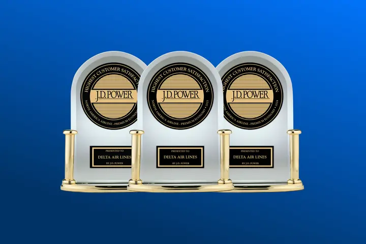 Three J.D. Power trophies against a blue background