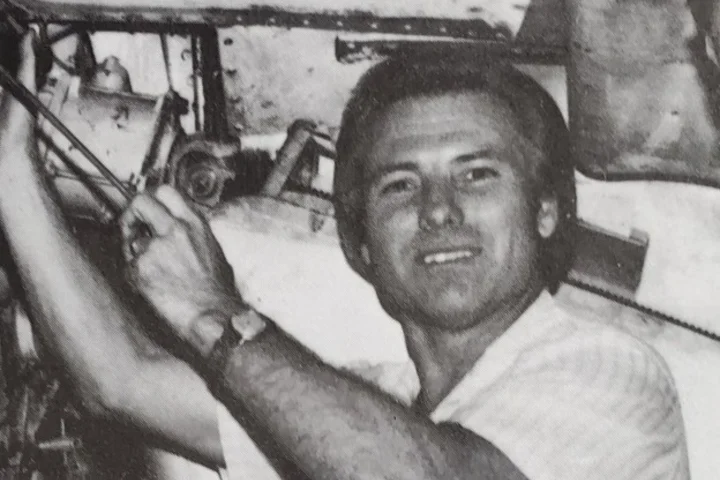 Black and white photo of Jimmy working on an airplane