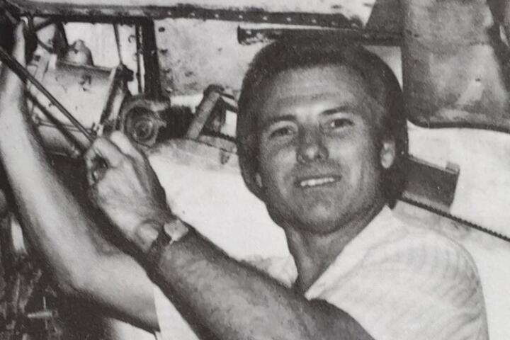 Black and white photo of Jimmy working on an airplane