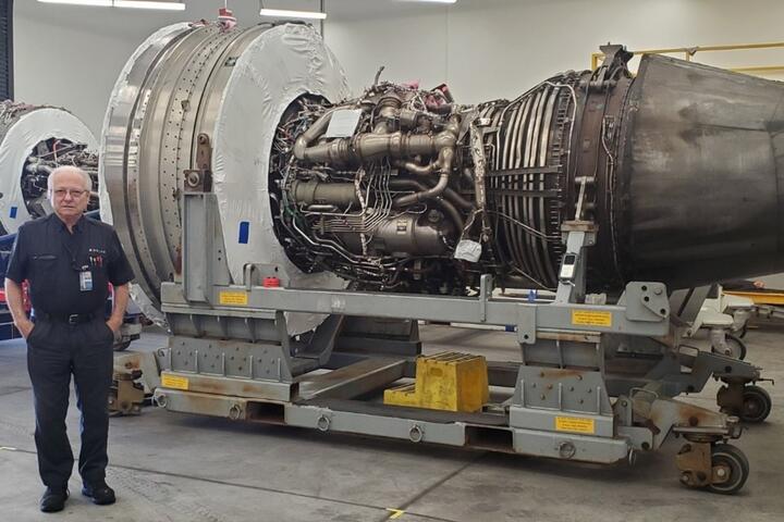 Jimmy posing in front of aircraft engine