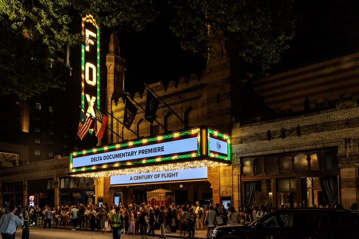 Exterior shot of the Fox Theatre at night with Delta documentary premiere on the marquee.