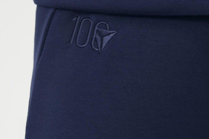 Close up of Delta Centennial logo embroidered on navy wide leg Spanx pants.