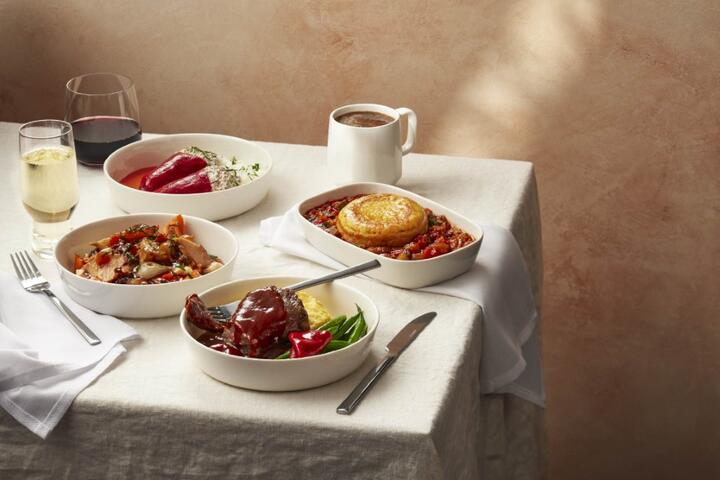 Various plated meals displayed on a table with a white tablecloth.