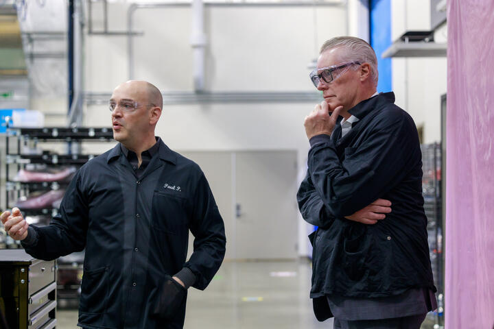 Ed Bastian and Amazon Leo employee standing in industrial facility.