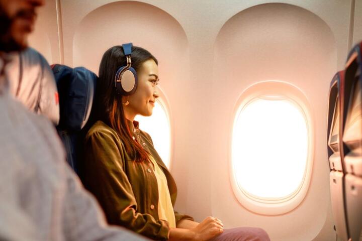A woman enjoys In-Flight Entertainment onboard a Delta flight.