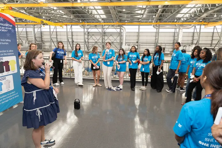 Students gather for a guided tour overlooking the Airbus aircraft manufacturing facility.