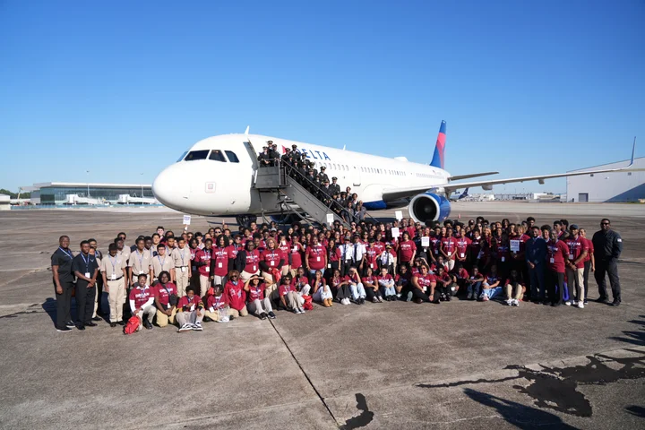 DREAM Flight participants, Delta employees and volunteers gather for a group photo in front of a Delta aircraft at Airbus’ Mobile, Alabama facility.