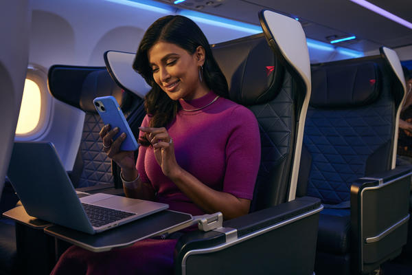 A Delta customer connects to free Wi-Fi while seated in the domestic first class cabin.