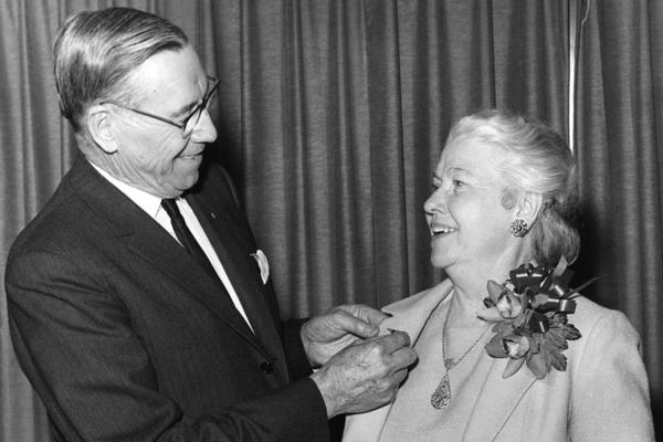 C.E. Woolman presents Catherine FitzGerald with a service pin in 1966, commemorating her 40-year aviation career.