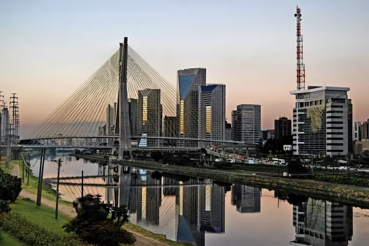 Sao Paulo landmark at dusk. Octavio Frias de Oliveira Stayed Bridge and modern buildings and districts of the skyline.