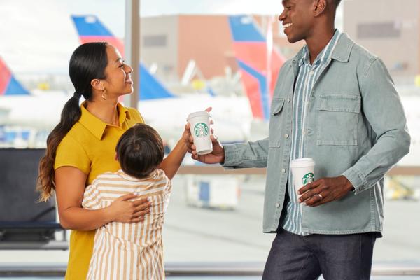 Family group of three enjoying Starbucks at airport