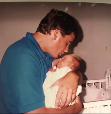 Greg Kaufmann holds his daughter, Adrienne.
