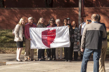 Honorees hold Chairman's Club flag