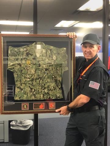 Mark Norris holding Navy uniform frame