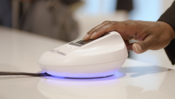 Guest places fingers on biometrics scanner