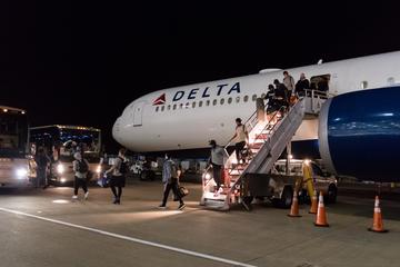 Seahawks team members deplaning from Delta jet 