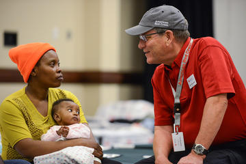 Red Cross volunteer and mother and daughter