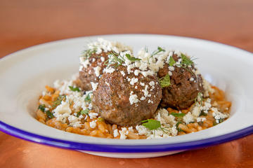 Black Sheep Foods' juicy, plant-based lamb meatballs are inspired by the highest-quality heritage breed lamb; the Greek-inspired dish is served with spinach rice and feta.