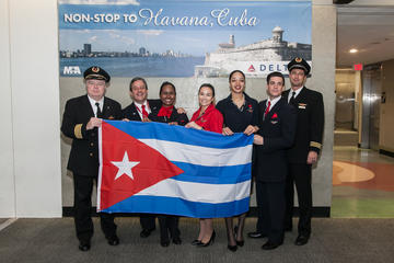 Delta employees with Cuba flag