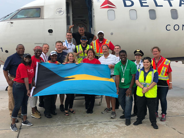 Bahamas relief flight photo with flag