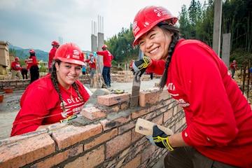 R10global-build-2018-two-women-building-wall.jpg