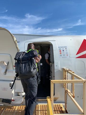 Delta employee boarding aircraft bound for Bahamas
