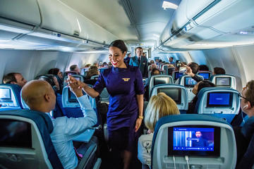 Flight attendant in new uniform during mid-flight fashion show