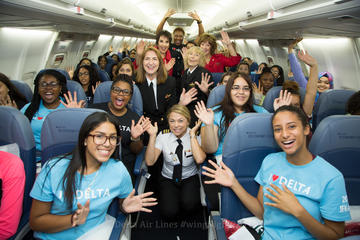 Girls and crew aboard the WING flight