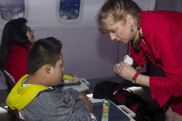 Flight attendant shows students what flying is like