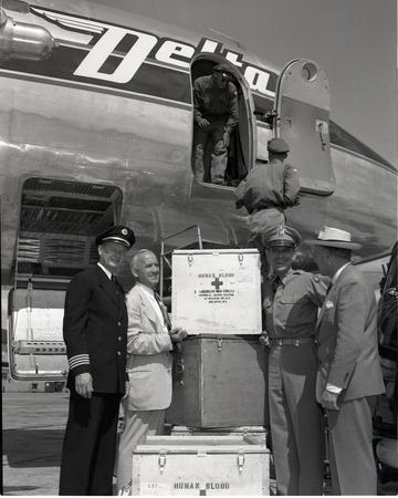 Korean War People standing in front of plane