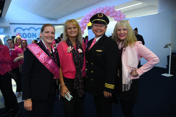 Wysong with employees on Breast Cancer Research Foundation flight