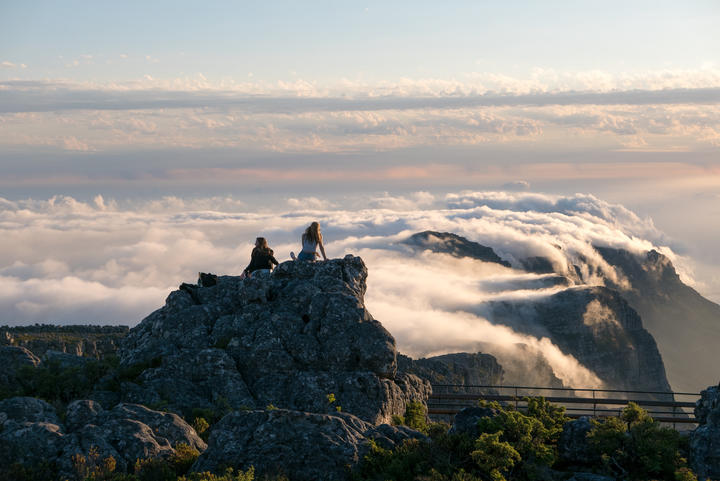 People on Table Mountain against cloudscape in Cape Town, South Africa.