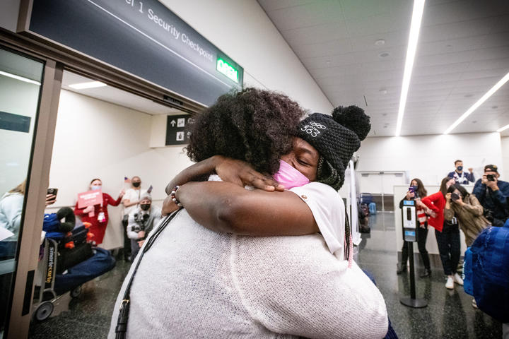 Maame Biney embraces a friend as Team USA athletes arrive at Salt Lake City International Airport in Salt Lake City, Utah on Monday, February 21, 2022.