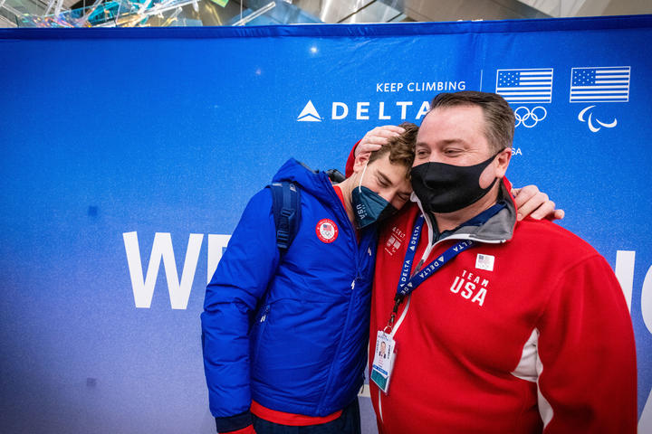 Brandon Frazier (left) and his uncle, Delta Air Lines First Officer Scott Frazier, share a moment as Team USA athletes arrive at Salt Lake City International Airport in Salt Lake City, Utah, on Monday, February 21, 2022.