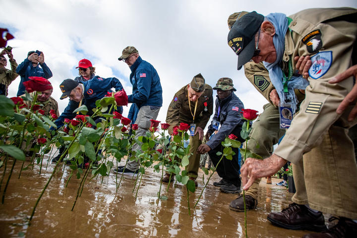 Delta veterans assist the World War II veterans in the rose-laying ceremony on Utah Beach.