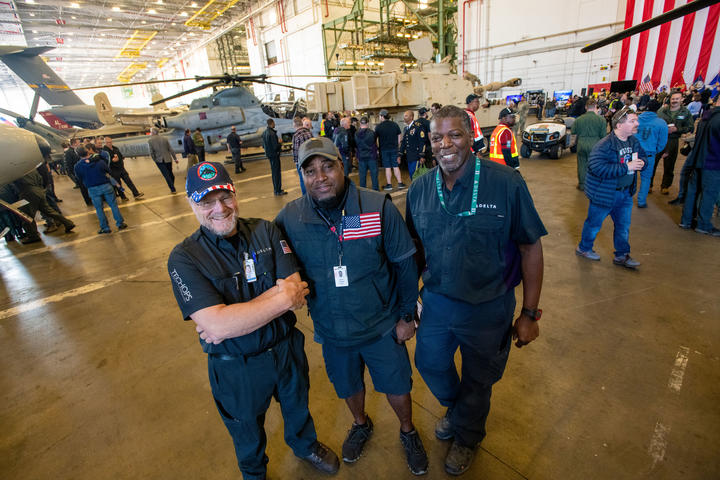 Three Delta TechOps employees pose for a photo at the airline's annual Veterans Day event on Nov. 4, 2022.