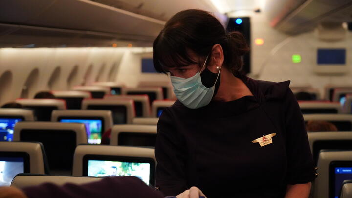 Delta Air Lines Flight Attendant serves passengers during CRAF mission.