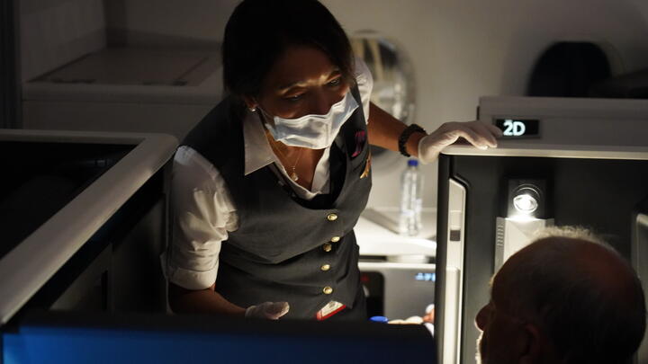 Delta Air Lines Flight Attendant serves passengers during CRAF mission.