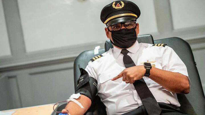 Captain Joe Pinkelton with mask giving blood