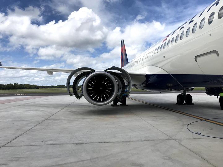 A220-300 aircraft on the tarmac with engine cowling open