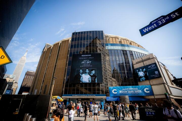 The Jonas Brothers live concert sign displayed on an outdoor screen at Madison Square Garden.