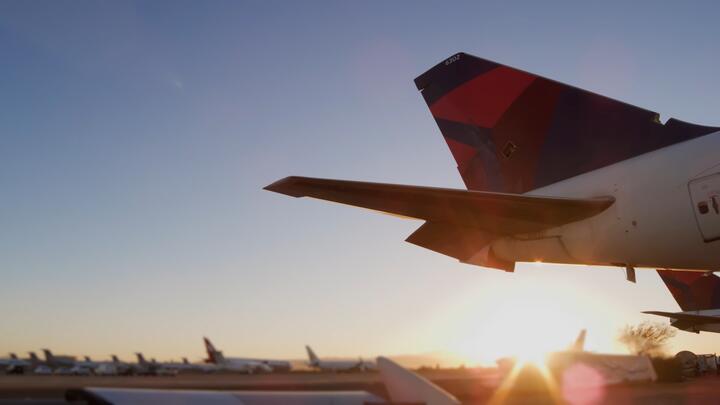 Sun rising behind tail of Boeing 747