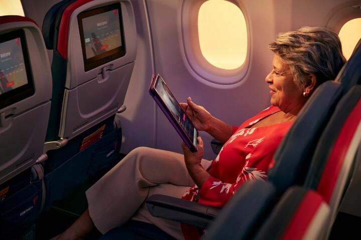 Delta customer using their tablet onboard.