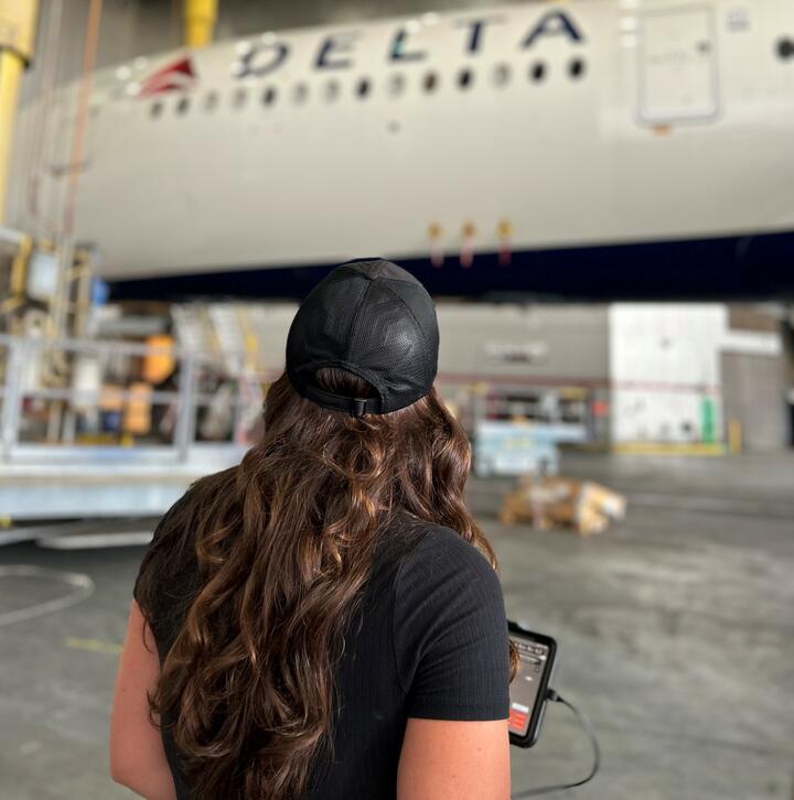 Emma Galarza, a senior engineer with TechOps, overseeing an autonomous drone inspection of a Delta Airbus A350-900.