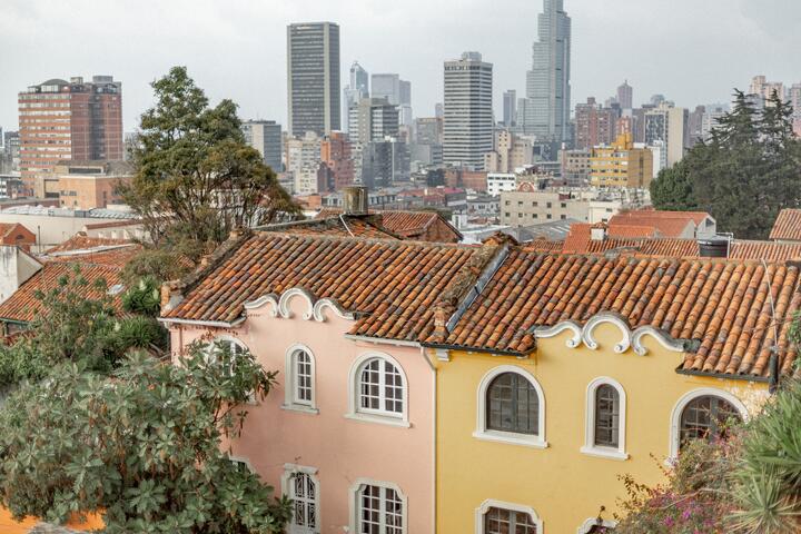 Old houses with new skyscrapers in the background in Bogota, Colombia