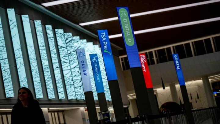 An airport with different check ins, including Delta's Digital ID.