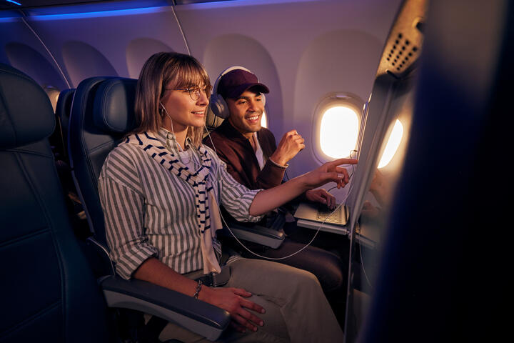 Customers browse seatback entertainment on a Delta flight.