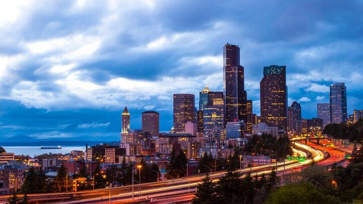 An image of downtown Seattle, lit up at night.