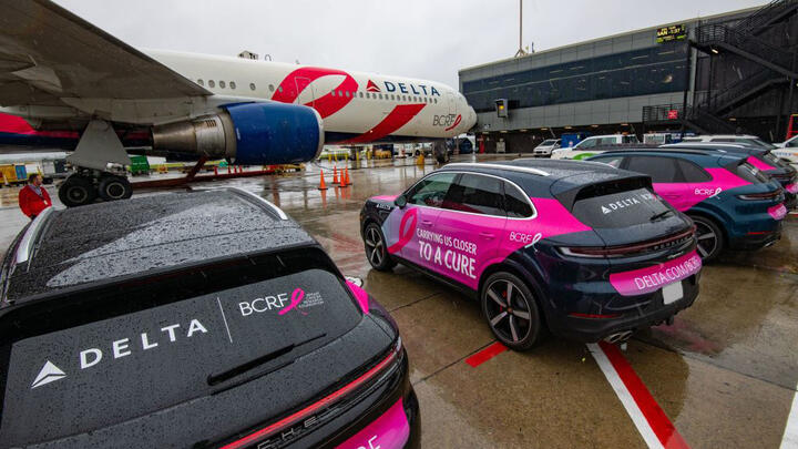 BCRF plane awaits takeoff amidst BCRF branded Porsches on September 26, 2024.