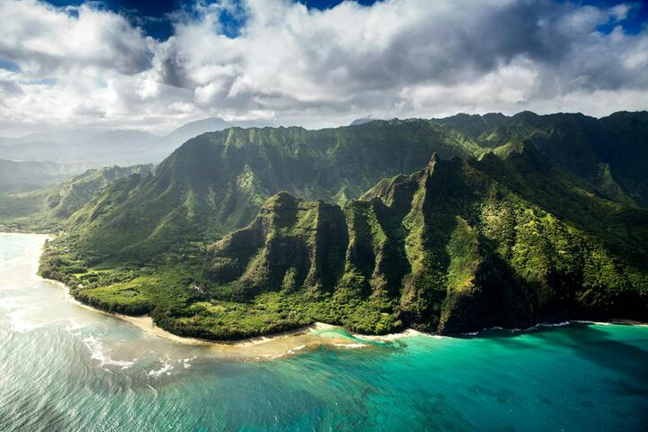 Aerial photography of green mountain beside body of water in Kauai, Hawaii